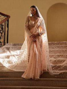 a woman in a wedding dress standing on stairs