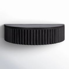 a black circular shelf on the wall with white walls in the background and an empty space for text