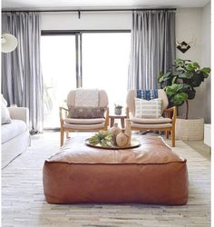 a living room filled with furniture and a large window