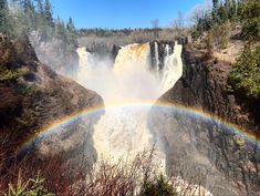 a large waterfall with a rainbow in the middle