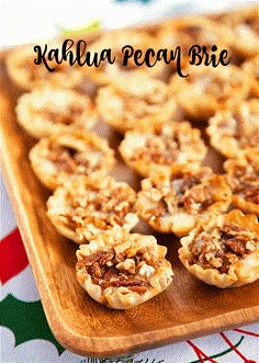 small pecan pies on a wooden platter with the words kahlua pecan bite