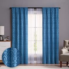 the curtains in this room are blue and have an animal motif on each window curtain