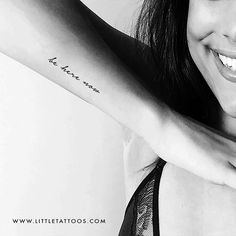 a woman with a tattoo on her arm smiling and holding onto the arm of another woman