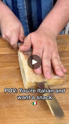 a person cutting bread with a knife on top of it and the words pov you're italian and want a snack