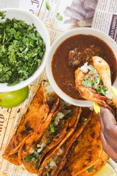 there is a plate of food on the table with sauce and other foods in bowls