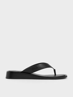 Achieve effortless style with these all-black thong sandals. Featuring a minimalist aesthetic marked by clean lines, these sandals come with thick, padded straps that create a perfectly symmetrical and pared-back look. They boast padded insoles and wedge soles that offer a slight elevation without compromising comfort, making them perfect for exploring the city or enjoying chic strolls along the beach. Most Comfortable Sandals, Strap Wedge, Pu Heels, Charles Keith, Comfortable Sandals, Minimalist Aesthetic, Thong Sandals, Black Sandals, Wedge Shoes