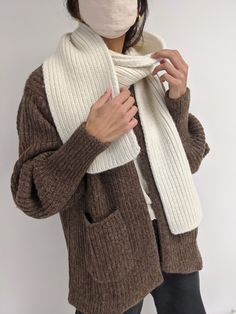 The CeCe Scarf is an exquisite piece knit from silky, dense baby alpaca yarn. It pairs perfectly with the Frankie Hat but can be worn in a variety of ways. Versatile and timeless, the CeCe scarf will become a staple in your cool-weather wardrobe, meant to be cherished for years to come. Ivory: Cream Oat: Tan Umber: Brown Ash: Grey Sky: Blue Onyx: Black 70% Baby Alpaca / 7% Merino Wool / 23% Synthetic Made in Peru Measurements: OS: 72” length / 8”width Full priced items purchased with a promotion Alpaca Scarf, Blue Onyx, Knit Alpaca, Alpaca Yarn, Baby Alpaca, Ash Grey, Scarf Shawl, Winter Scarf, Alpaca