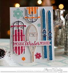 a close up of a card on a table with snowflakes and other decorations