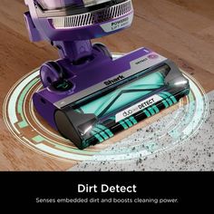 a purple robot is on the floor with dirt