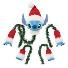 a stuffed toy with christmas decorations on it's head and hands in the shape of letters