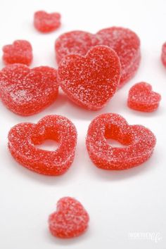 red candies shaped like hearts on a white surface