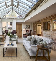 a living room filled with furniture and a skylight