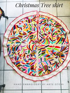 a colorful christmas tree skirt on the floor