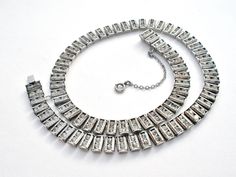 Designer Jewelry - This is a vintage sterling silver necklace with 2 rows of clear rhinestones. It is hallmarked Sterling, signed Catamore, 15" long, slightly over .25" wide, weighs 37.8 grams, has slide in locking clasp and safety chain. Vintage Silver Diamond Necklace, Silver Double Strand Jewelry For Evening, Vintage Silver Diamond Necklace For Formal Occasions, Vintage Silver Diamond Necklace For Evening, Silver Rhinestone Necklace With Diamond Accents, Vintage Silver Diamond Necklace For Anniversary, Vintage Silver Sparkling Necklace, Silver Diamond Rhinestone Necklace Costume Jewelry, Vintage Silver Double Strand Jewelry