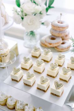 desserts and pastries are arranged on a white platter at a wedding reception