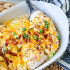 a casserole dish with chicken, cheese and green onions