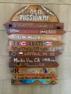 a wooden sign that has many different signs on it