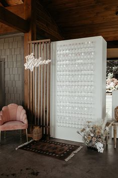 a room with a chair, rug and wall decoration