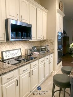 a kitchen with white cabinets and granite counter tops