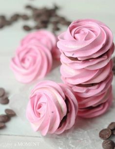 some pink frosted cupcakes with chocolate chips around them