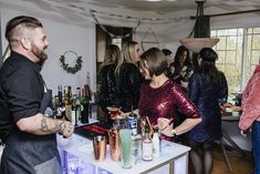 a group of people standing around a bar