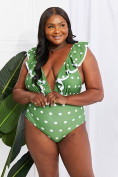 Make your inner beach babe shine by wearing a suit that makes you feel confident. This one is designed with a deep neckline and a ruffle trim. You can get double the use of this swimsuit by styling it as a bodysuit under a skirt or pair of jeans. Note: Runs small, order one size up. If between sizes or have a long torso, please size up. Top type: No underwire Sizing category: Regular Pattern type: Polka dot Features: Ruffle Neckline: Plunge Material: 83% polyester, 17% spandex Stretch: Moderate Plunge Swimsuit, Fashion District, Green Swimsuit, Tropical Floral Print, Long Torso, Deep Neckline, Beach Babe, Sporty Look, Creative Fashion