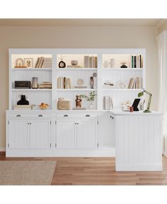 a white bookcase filled with lots of books