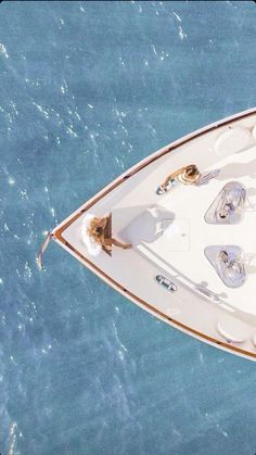 an aerial view of a white boat in the water