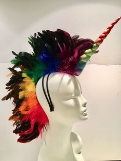 Pride- Unicorn cosplay- feather Head Piece- Rainbow- Burning Man- Music Festival Hello, This piece has a 10 inch fabric unicorn in the front. Down the center are coque feathers that are 6 to 7 inch off the head. The edge close to the head are marabou feathers. It's all attached to a 1/4 inch stainless steel headband wrapped satin material. The headband is a double so it stays on your head while you dance! I can in any color to match your hair. This headband is very comfortable. ----------------- Multicolor Novelty Costume Accessories For Carnival, Multicolor Novelty Costume Hats For Carnival, Novelty Multicolor Costume Hats For Carnival, Multicolor Rave Costume Accessories, Multicolor Rave Costume Accessories For Costume Party, Feather Costume Accessories For Carnival Cosplay, Themed Multicolor Costume Accessories For Carnival, Feathered Costume Hats And Headpieces For Mardi Gras, Feathered Hats And Headpieces For Mardi Gras Costume Party