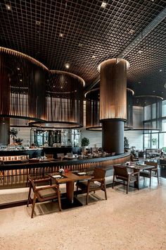 an empty restaurant with wooden tables and chairs