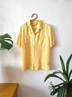 Vintage women's light yellow silk blouse / button up shirt -two chest pockets -shoulder pads Good vintage condition, some small scratches on the back, please see the pictures Tag: Martinelli, made in China Material: 100% Silk Size on tag: 44 Measurements taken lying flat CHEST: 59cm // 23,22 in WAIST: 59cm // 23,22 in LENGTH: 71cm // 27,95 in Please remember to double chest, waist, and hip for exact measurements and compare them to your own clothes. Vintage sizes do not always correlate with mod 90s Style Relaxed Fit Button-up Top, Vintage Short Sleeve Blouse With Pockets, 90s Short Sleeve Tops With Button Closure, Vintage Blouse With Pockets In Relaxed Fit, Vintage Blouse With Pockets And Relaxed Fit, Vintage Blouse With Pockets Relaxed Fit, Vintage Relaxed Fit Blouse With Pockets, Retro Tops With Pockets And Relaxed Fit, Retro Relaxed Fit Tops With Pockets