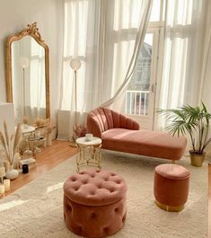 a living room filled with furniture and a large mirror on the wall above it's windows