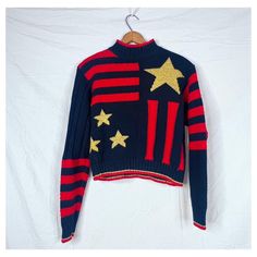 Vintage 90s Cable Knit Gold Star Sweater  Thick cotton cable knit with rubbed panels  Black with patchwork style composition  Red stripes and gold stars  Mock neck with ribbed hems and cuffs  Matching stripes on one different parts of either sleeve  Copped length Labeled size small Sweater With Stars, Star Sweater, Black Panels, Pullover Sweater Women, Gold Star, Cable Knit Sweater, Gold Stars, Women Pullover, Cable Knit