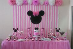 a minnie mouse party with pink and white decorations