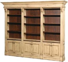 a large wooden bookcase with doors and drawers