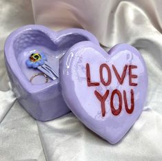 a purple heart shaped box with the words love you written on it