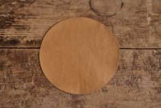 a round brown piece of paper sitting on top of a wooden table