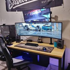 a computer desk topped with two monitors and a keyboard