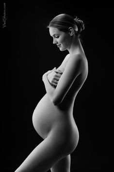 a black and white photo of a pregnant woman