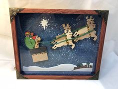 a christmas scene with santa sleigh, reindeers and snowman in the sky