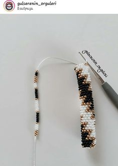 the beaded bracelet is being worked on by a crochet hook and thread