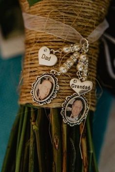 a bunch of flowers with some pictures on them and two charms attached to the stems