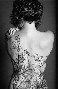 the back of a woman's body with flowers on it