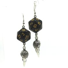 For Raven Queen worshippers who don't want to wear our huge and heavy (but very cool) raven earrings, we also offer this smaller, lighter (but still very cool) version. Each has a night-black D20. Beneath the dice hang silvery raven skull charms. These would be a perfect accessory for someone playing a member of the shadar-kai or a cleric that worships the Raven Queen. A great gift for players of D&D, Pathfinder, and other tabletop RPGs -- or for anyone who wants to geek out with a fun and myste Handmade Black Fantasy Earrings, Black Fantasy Earrings, Black Fantasy Style Pierced Earrings, Black Fantasy Style Earrings, Black Skull Earrings For Gift, Adjustable Black Skull-shaped Earrings, Adjustable Black Skull Earrings, Black Fantasy Dangle Jewelry, Nickel Free Black Skull Earrings