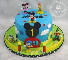 a birthday cake with mickey mouse and friends on it