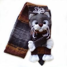 a knitted scarf with a cat on it