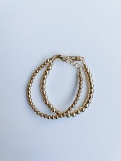 This stunning 3mm Goldie Bracelet is crafted with gold-filled beads for lasting beauty and durability. Its anti-tarnish finish ensures this elegant accessory will remain lustrous for years to come, making it the perfect accessory for any occasion. Made to last with 14k gold hardware. Check out our size guide for help with bracelet sizing. Comes in baby through adult sizes. We look forward to seeing pictures of you and your sweet girls wearing your bracelets #joyfulbead. * Due to the nature of ou Gold Bead Bracelet, Gold Bead Bracelets, Elegant Accessories, Pictures Of You, Girls Wear, Sweet Girls, Gold Beads, See Picture, Handmade Bracelets