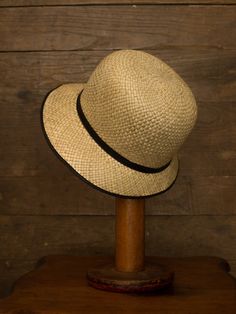 "An authentic antique woven cloche from the late 1920s or 30s era. Originally acquired by a European hat shop that closed in the 1930s. Made from a light colored woven straw with a simple yet elegant black wax coated ribbon and buckle. Only minor signs of age from storage, never been previously used. Centimeter measurements written on the inside of the crown by the hat maker. material : straw, silk? ribbon color : black, light beige condition : little to no wear, has never been used size : pleas Classic Adjustable Cloche Hat, Adjustable Classic Cloche Hat, Adjustable Cloche Hat In Flapper Style, Adjustable Cloche Flapper Hat, Gatsby Style Wide Brim Adjustable Hats, Vintage Fitted Brimmed Panama Hat, Vintage Short Brim Panama Hat For Kentucky Derby, Vintage Panama Hat For Kentucky Derby With Short Brim, Adjustable Wide Brim Flapper Hat