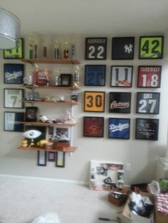 a room with many framed sports memorabilia on the wall