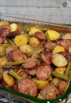 a glass dish filled with potatoes and green beans